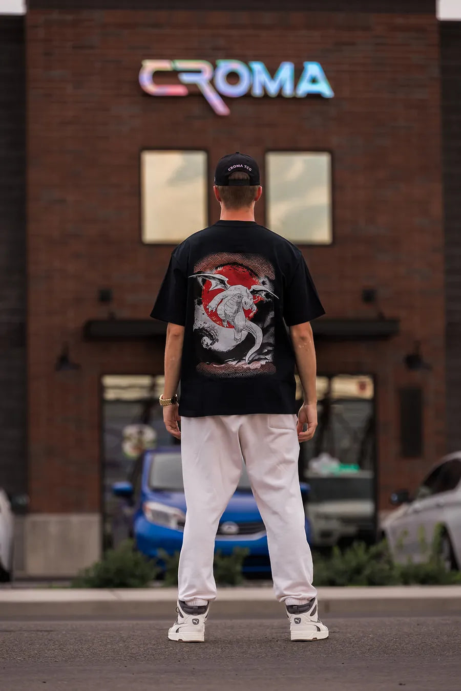 CR chest logo tee and pink-R cap outside the Croma storefront