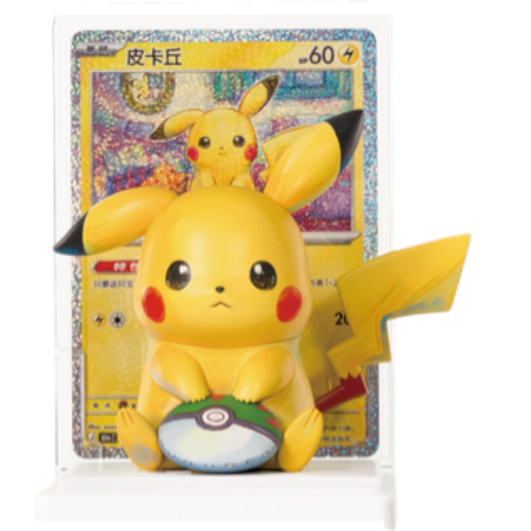 Pikachu figure with Poké Ball on a display stand beside its matching foil card